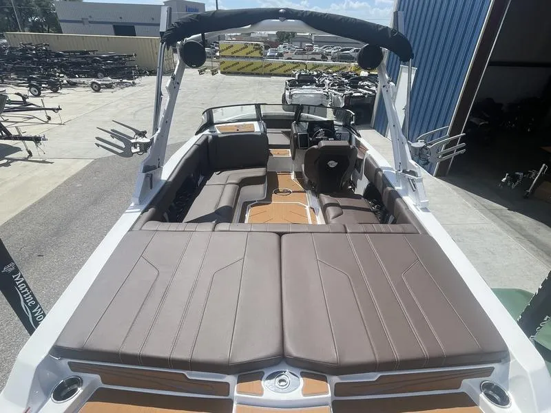 Slide: The Image of 2024 Malibu 21 LX boat with spacious seating and modern design. - 15