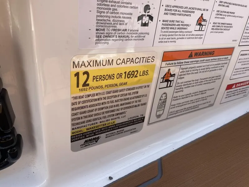 Slide: The Image of 2024 Malibu 21 LX boat capacity label, maximum 12 persons or 1692 lbs. - 17