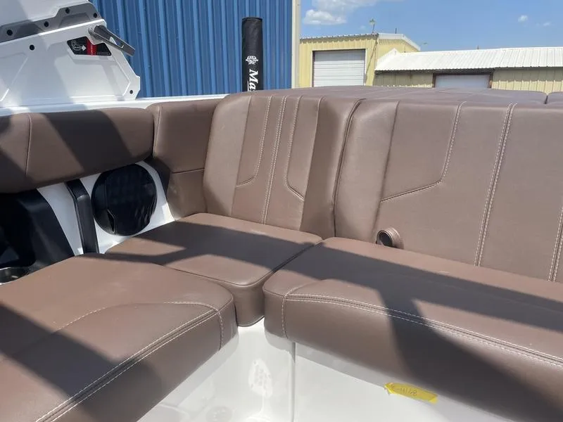 Slide: The Image of 2024 Malibu 21 LX boat interior with brown leather seating. - 8
