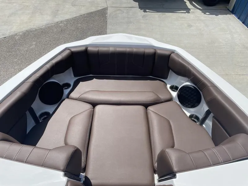 Slide: The Image of 2024 Malibu 21 LX boat interior with brown leather seating and built-in speakers. - 9