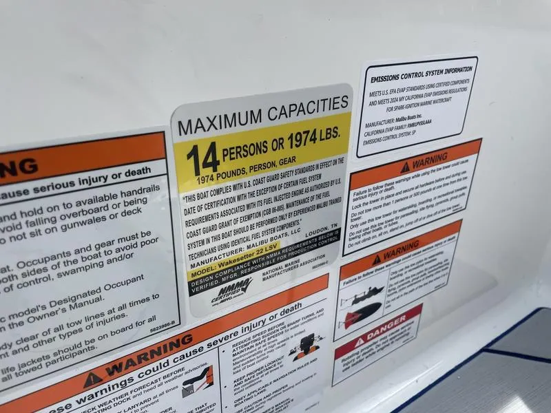 Slide: The Image of 2024 Malibu 22 LSV boat capacity and safety warning labels. - 10