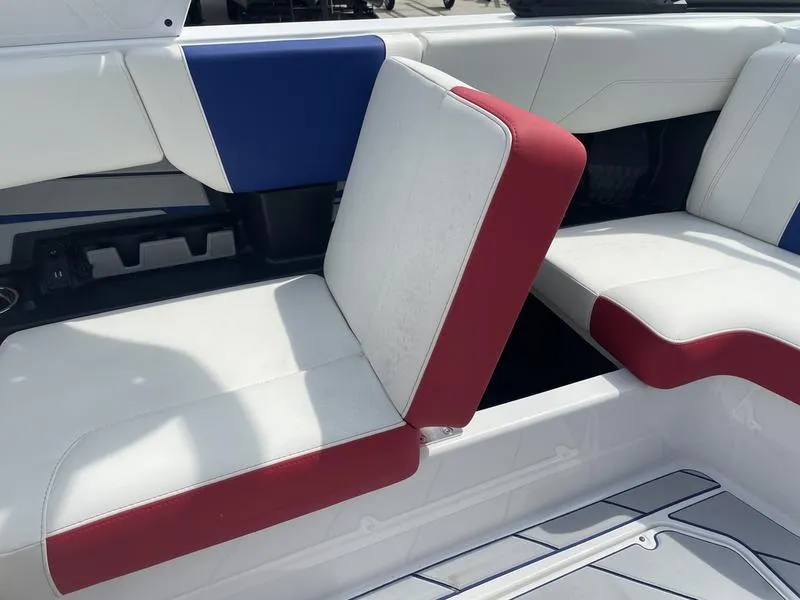 Slide: The Image of 2024 Malibu 22 LSV boat interior with white, red, and blue seating. - 12