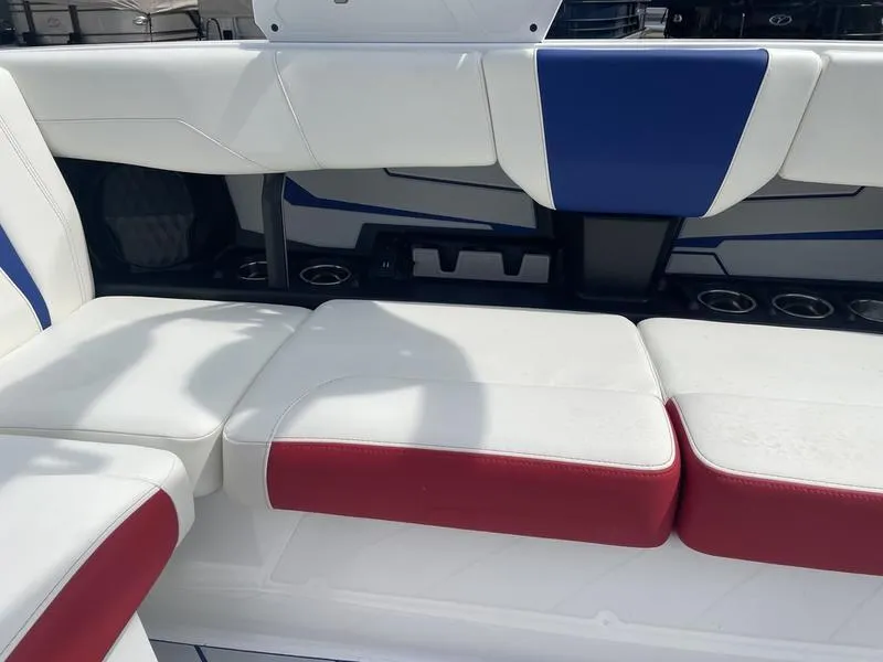 Slide: The Image of 2024 Malibu 22 LSV boat interior with white, red, and blue seating. - 19