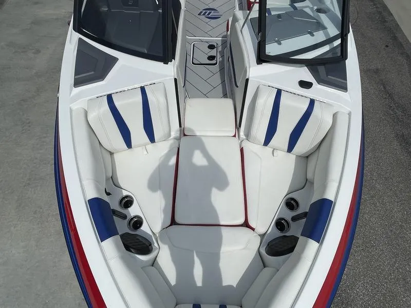 Slide: The Image of 2024 Malibu 22 LSV boat interior with white, blue, and red seating. - 20
