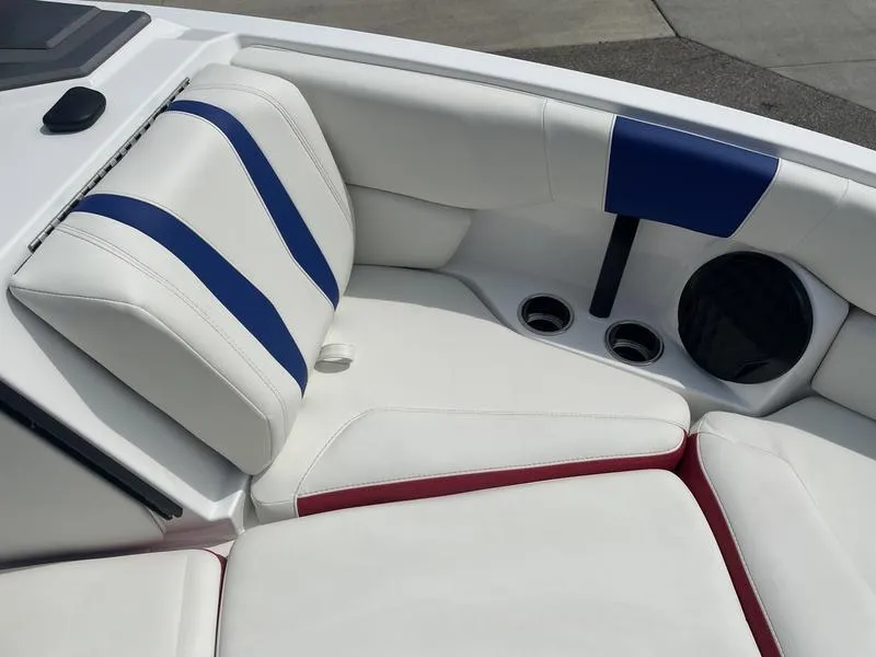 Slide: The Image of 2024 Malibu 22 LSV boat interior with white, blue, and red upholstery. - 21