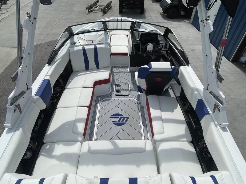 Slide: The Image of 2024 Malibu 22 LSV boat interior with white, blue, and red seating. - 23