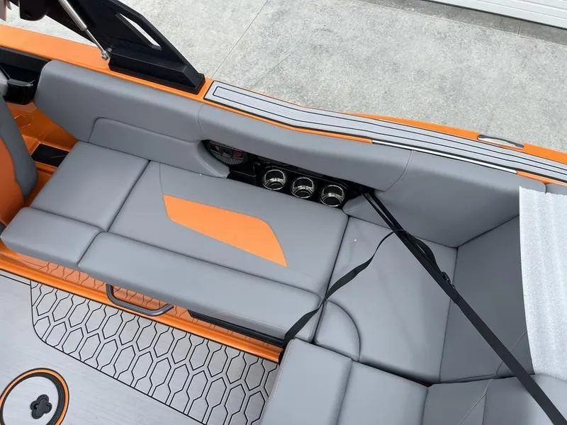 Slide: The Image of 2024 MasterCraft NXT23 boat interior with gray and orange seating. - 10