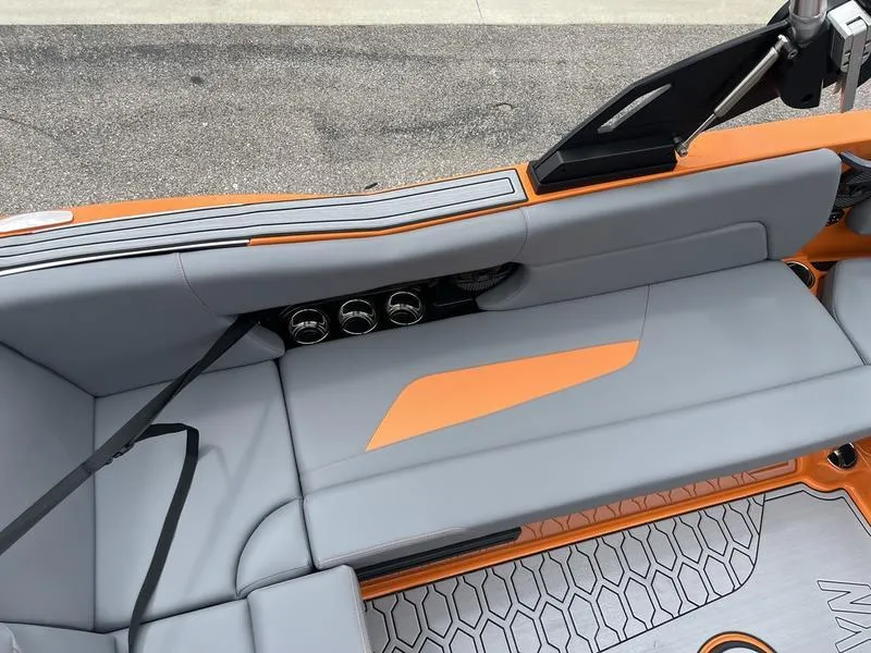Slide: The Image of 2024 MasterCraft NXT23 boat interior with gray and orange seating. - 11