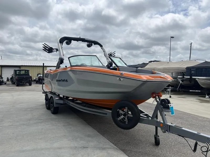 Slide: The Image of 2024 MasterCraft NXT23 boat on trailer in outdoor lot. - 2