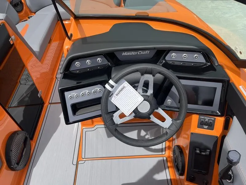Slide: The Image of 2024 MasterCraft NXT23 boat dashboard with steering wheel and control panel. - 5