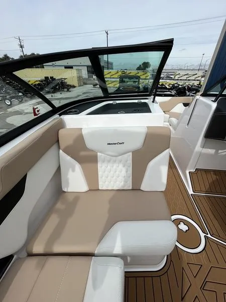 Slide: The Image of 2024 MasterCraft XT20 boat interior with beige and white seating. - 13