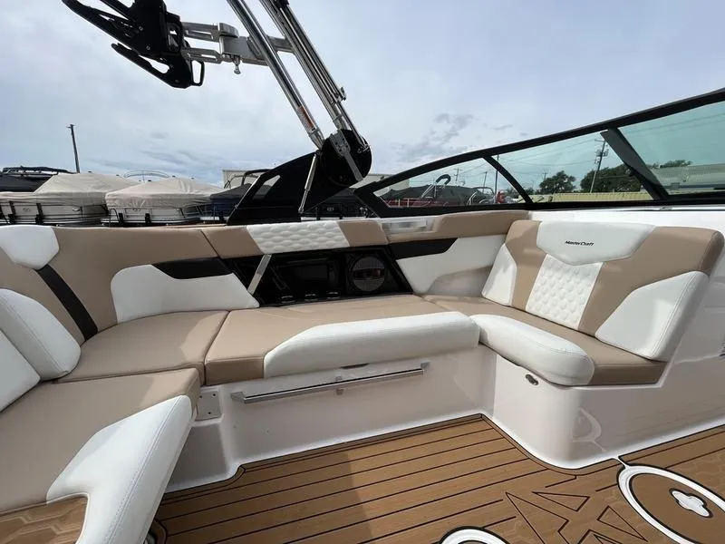 Slide: The Image of 2024 MasterCraft XT20 boat interior with beige and white seating. - 14