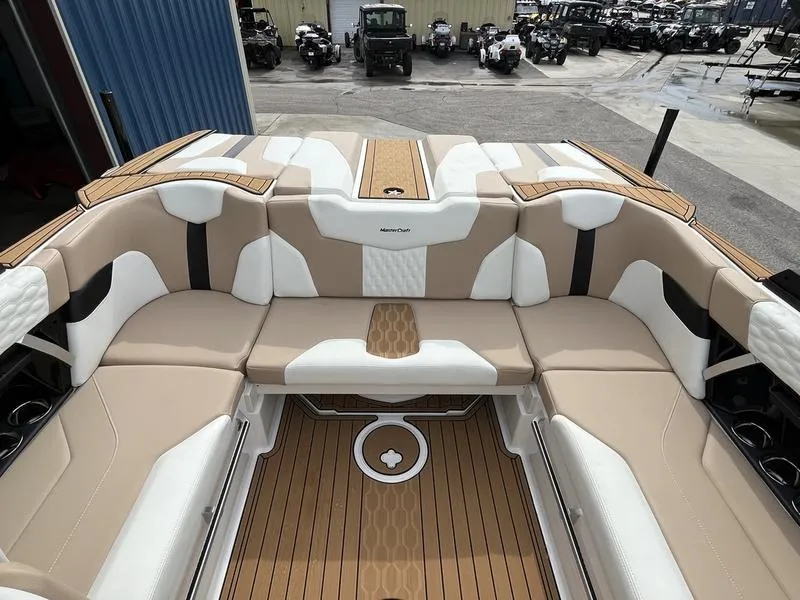 Slide: The Image of 2024 MasterCraft XT20 boat interior with beige and white seating. - 16