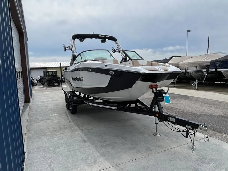 Slide: The Image of 2024 MasterCraft XT20 boat on trailer in marina. - 2