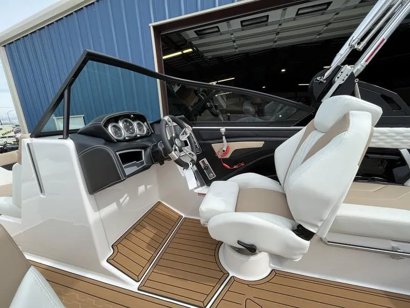 Slide: The Image of 2024 MasterCraft XT20 boat interior with white seats and wooden flooring. - 7