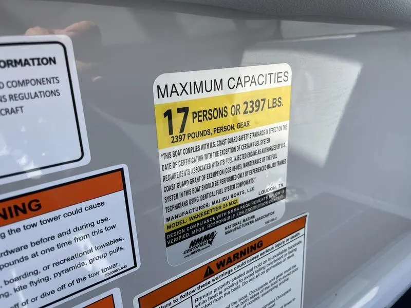 Slide: The Image of 2023 Malibu 24 MXZ boat capacity label, 17 persons or 2397 lbs maximum. - 10