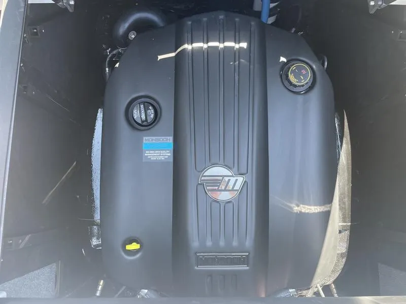 Slide: The Image of 2023 Malibu 24 MXZ engine compartment with a powerful inboard motor. - 16