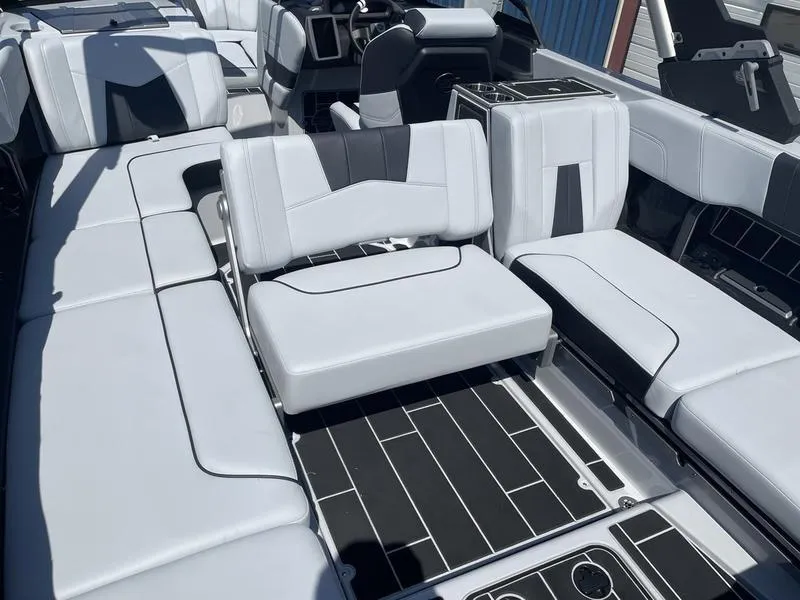 Slide: The Image of 2023 Malibu 24 MXZ boat interior with luxurious seating and modern design. - 17