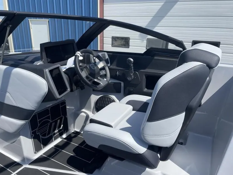 Slide: The Image of 2023 Malibu 24 MXZ boat interior with modern dashboard and comfortable seating. - 21