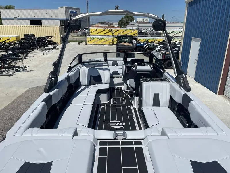 Slide: The Image of 2023 Malibu 24 MXZ boat interior with spacious seating and modern design. - 23