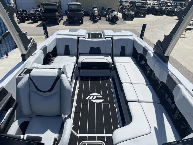 Slide: The Image of 2023 Malibu 24 MXZ boat interior with spacious seating and modern design. - 26