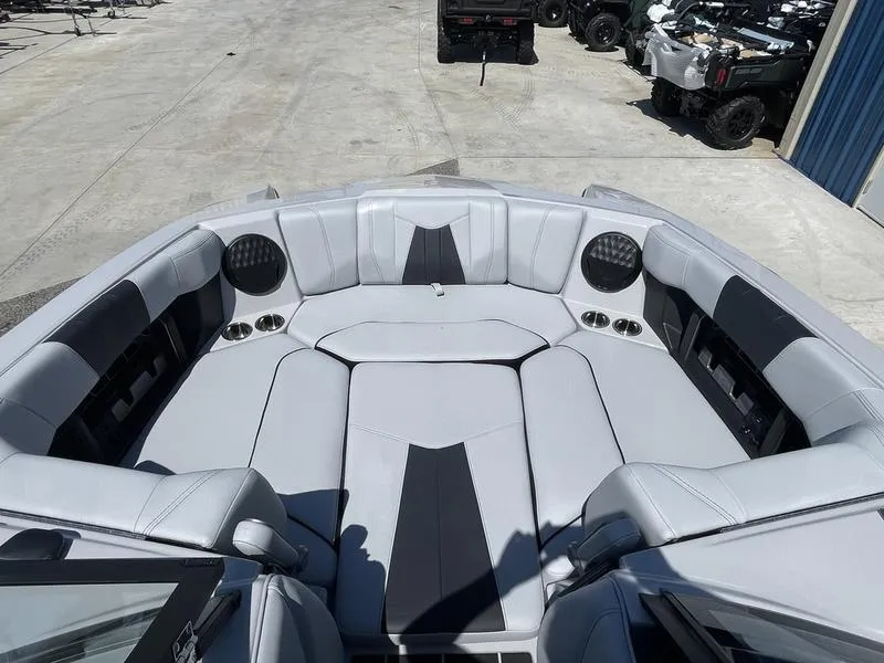 Slide: The Image of 2023 Malibu 24 MXZ boat with spacious, luxurious seating and built-in speakers. - 8