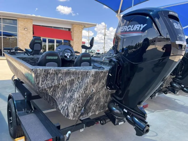 Slide: The Image of 2024 Havoc Boats 1756 FRRSC with Mercury engine, parked outdoors under blue sky. - 4