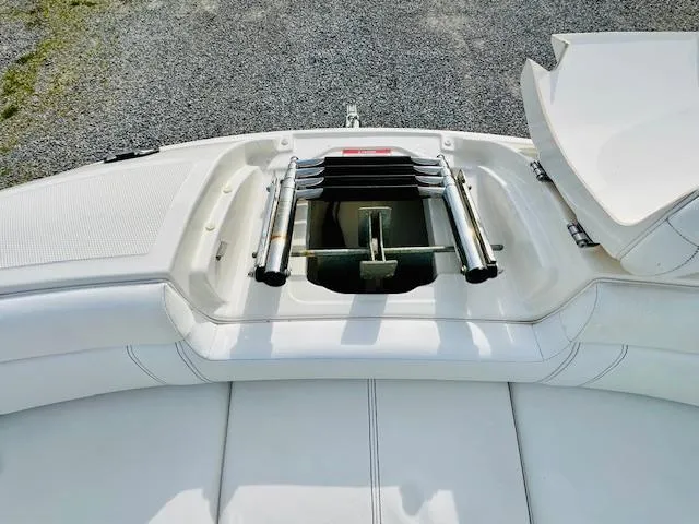 Slide: The Image of 2018 Sea Ray 270 SDX boat ladder compartment, open on white deck. - 10