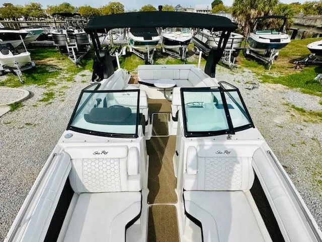 Slide: The Image of 2018 Sea Ray 270 SDX boat with spacious seating and sleek design, docked outdoors. - 12