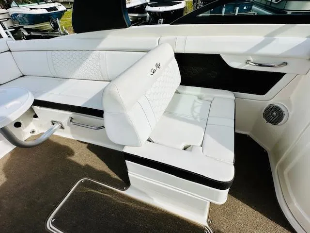 Slide: The Image of 2018 Sea Ray 270 SDX boat interior with white seating and elegant design. - 14