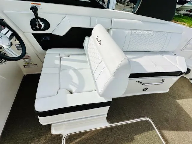 Slide: The Image of 2018 Sea Ray 270 SDX boat interior with white seating and steering wheel. - 15