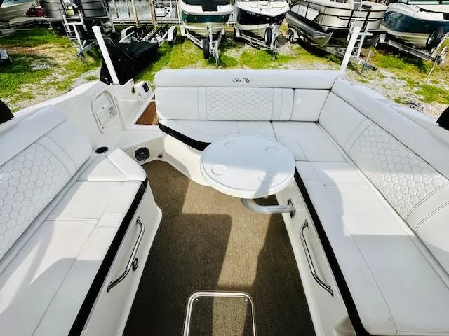Slide: The Image of 2018 Sea Ray 270 SDX boat interior with white seating and round table. - 16