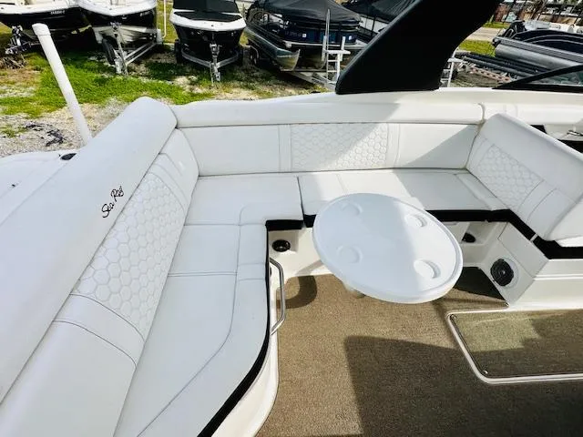 Slide: The Image of 2018 Sea Ray 270 SDX boat interior with white seating and round table. - 17
