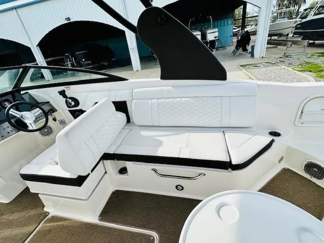 Slide: The Image of 2018 Sea Ray 270 SDX boat interior with white seating and steering wheel. - 19