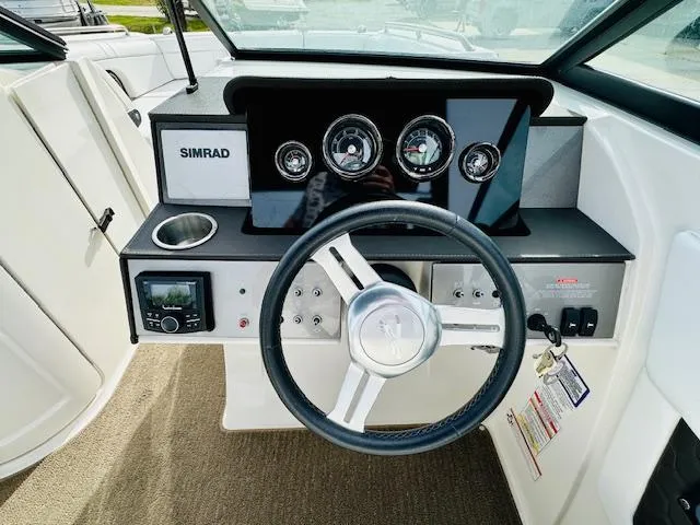 Slide: The Image of 2018 Sea Ray 270 SDX boat dashboard with steering wheel and Simrad display. - 20
