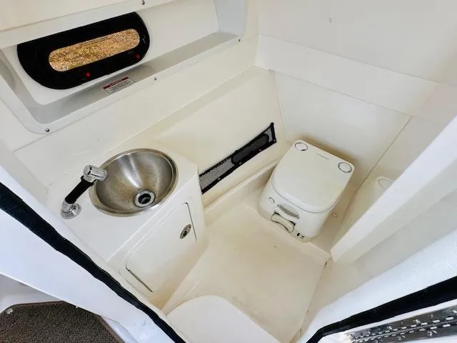Slide: The Image of 2018 Sea Ray 270 SDX boat interior with sink and portable toilet. - 22