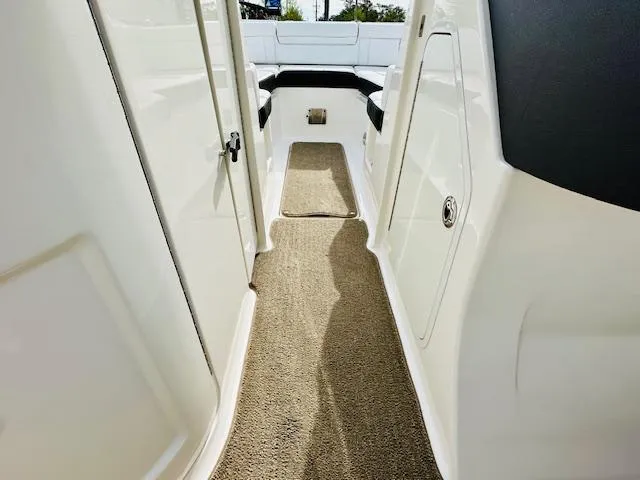 Slide: The Image of 2018 Sea Ray 270 SDX interior with carpeted walkway and seating area. - 23