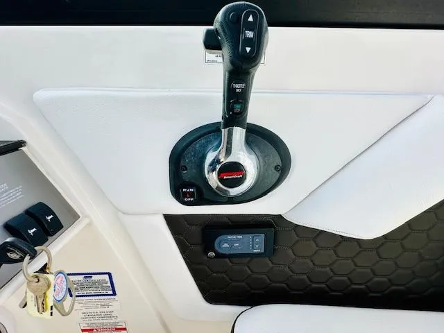 Slide: The Image of Control panel of a 2018 Sea Ray 270 SDX boat with throttle lever and key ignition. - 24
