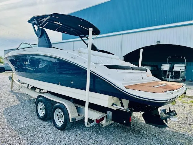 Slide: The Image of 2018 Sea Ray 270 SDX boat on trailer, parked outside a blue building. - 3