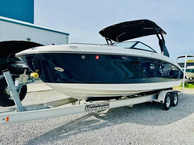 Slide: The Image of 2018 Sea Ray 270 SDX boat on trailer, parked outdoors near a blue building. - 5