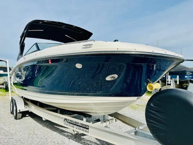 Slide: The Image of 2018 Sea Ray 270 SDX boat on trailer, blue hull, sunny day. - 6
