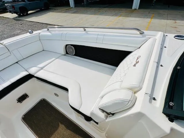 Slide: The Image of 2018 Sea Ray 270 SDX boat interior with white cushioned seating and speaker. - 8