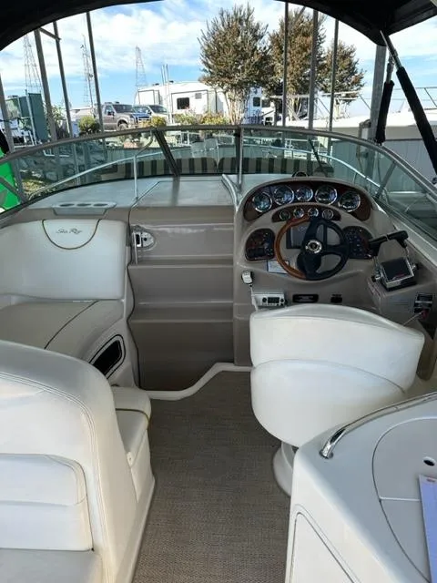 Slide: The Image of 2003 Sea Ray 280 Sundancer boat cockpit with steering wheel and dashboard. - 15