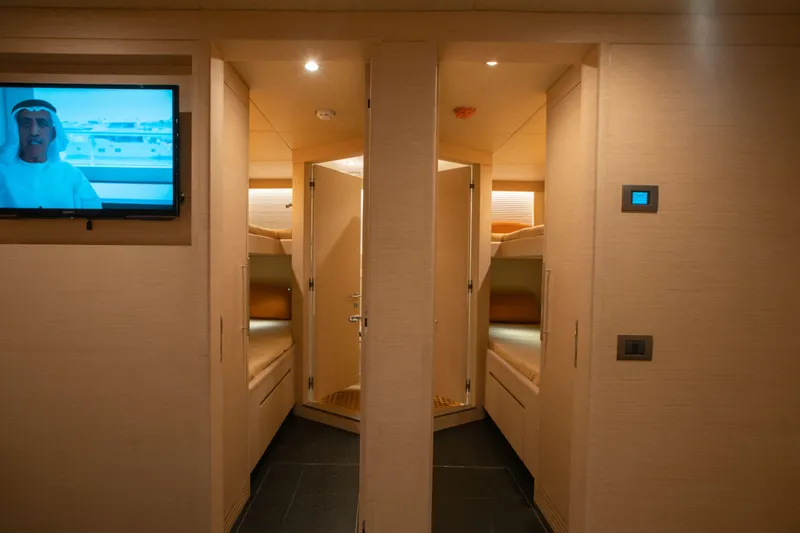 Slide: The Image of Interior of 2025 Nomad 95 SUV yacht with cozy bunk beds and modern amenities. - 16