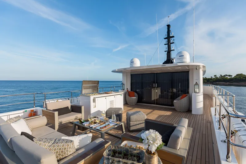 Slide: The Image of Luxurious deck of 2025 Nomad 95 SUV yacht with elegant seating and ocean view. - 23