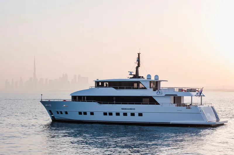 Slide: The Image of Luxury Nomad 95 SUV yacht cruising with city skyline backdrop, 2025 model. - 26