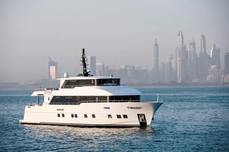 Slide: The Image of Luxury Nomad 95 SUV yacht cruising with city skyline backdrop, 2025 model. - 30