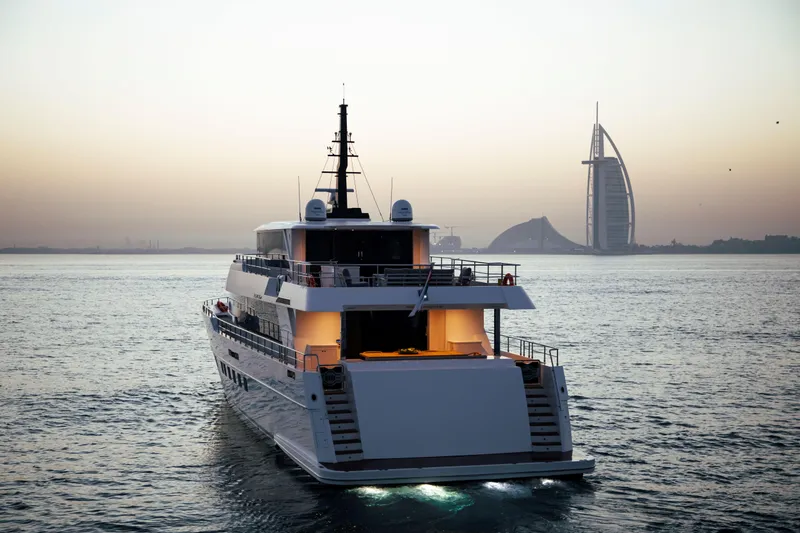 Slide: The Image of Luxurious Nomad 95 SUV yacht cruising near iconic Dubai skyline at sunset, 2025 model. - 33