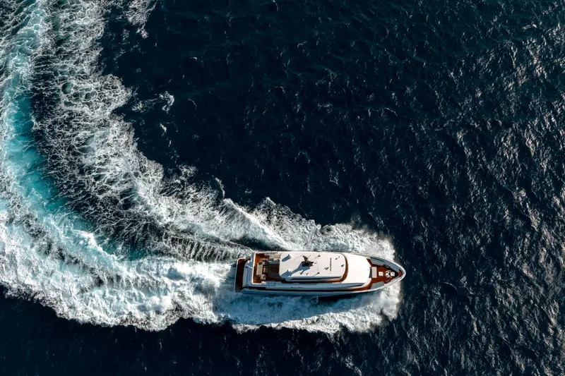 Slide: The Image of Aerial view of 2025 Nomad 95 SUV yacht cruising through ocean waves. - 40