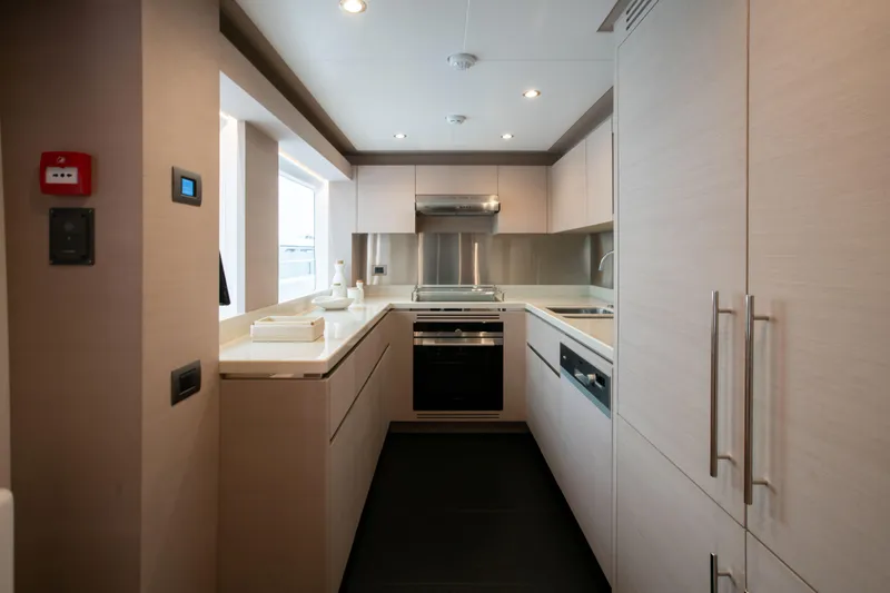 Slide: The Image of Modern kitchen interior in 2025 Nomad 95 SUV yacht, featuring sleek cabinetry and stainless steel appliances. - 5